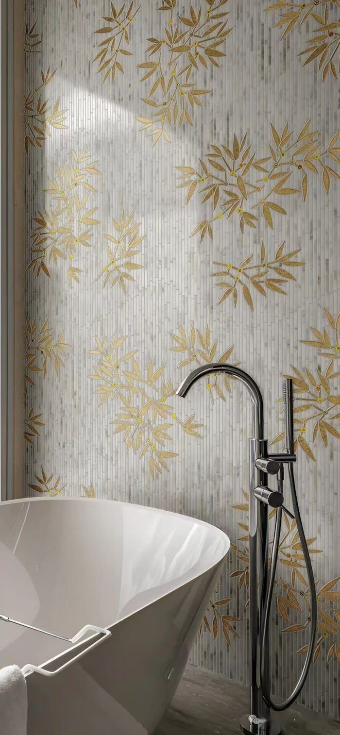 Gold amber and cream glass mosaic wall of bamboo leaves in a luxury spa bathroom